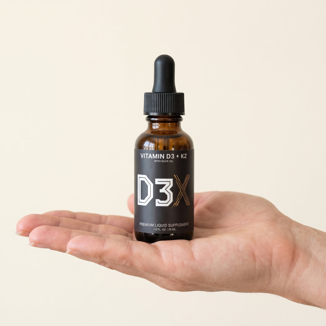 A D3X bottle held in an open hand